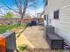 Back patio featuring outdoor cooking area with grill and grassy yard and wood fence at 10781 Moore St, Westminster, CO 80021