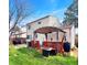 Spacious backyard featuring a pergola with seating, grass, and mature trees at 10781 Moore St, Westminster, CO 80021
