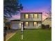 Charming two-story home with well-manicured lawn, garage, and colorful sunset at 10781 Moore St, Westminster, CO 80021
