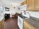 This open floorplan connects the kitchen, complete with white appliances, to the inviting dining area filled with light at 10781 Moore St, Westminster, CO 80021