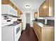 Well-maintained kitchen featuring a white appliance package and warm wood cabinetry providing ample storage and workspace at 10781 Moore St, Westminster, CO 80021