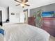 A spacious bedroom filled with natural light from the large window and featuring a ceiling fan and soft carpeting at 10781 Moore St, Westminster, CO 80021