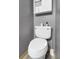 This half bath is designed with a white toilet, neutral walls, and modern fixtures for a fresh, clean look at 10781 Moore St, Westminster, CO 80021