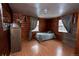 Rustic bedroom featuring wood walls and floors, with two windows providing plenty of natural light at 1134 Del Mar Pkwy, Aurora, CO 80010