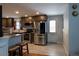 Modern kitchen features stainless steel appliances, dark cabinets, light countertops, and tile flooring at 1134 Del Mar Pkwy, Aurora, CO 80010