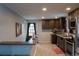 Modern kitchen features stainless steel appliances, dark cabinets, white subway tile, and light countertops at 1134 Del Mar Pkwy, Aurora, CO 80010
