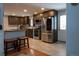 Modern kitchen features stainless steel appliances, dark cabinets, light countertops, and tile flooring at 1134 Del Mar Pkwy, Aurora, CO 80010