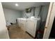 Functional laundry room in the basement featuring washer, dryer, and utility sink at 1134 Del Mar Pkwy, Aurora, CO 80010