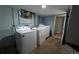 Practical basement laundry room equipped with washer, dryer, utility sink, and ample working space at 1134 Del Mar Pkwy, Aurora, CO 80010