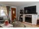 Cozy living room with a fireplace, TV, and a comfortable seating area, with hardwood floors and decor at 1134 Del Mar Pkwy, Aurora, CO 80010