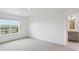 Bright, empty room featuring neutral walls, carpeted floors, and window bringing in natural light at 4115 Marble Dr, Mead, CO 80504