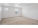 Bright, empty room features neutral walls, carpeted floors, and two windows bringing in natural light at 4115 Marble Dr, Mead, CO 80504
