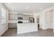 Bright kitchen featuring stainless steel appliances, quartz countertops, an island, and a pantry at 4115 Marble Dr, Mead, CO 80504
