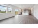 Bright living room and kitchen featuring hard wood floors, modern appliances, and sliding door to backyard at 4115 Marble Dr, Mead, CO 80504