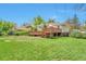 Expansive backyard with lush green lawn and deck, ideal for outdoor activities and relaxation at 6484 Kendall St, Arvada, CO 80003