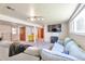 Finished basement with a sectional sofa and a TV for entertainment, also includes unique yellow drawers at 6484 Kendall St, Arvada, CO 80003