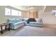 Finished basement with carpet and light blue sofa, perfect for relaxing or entertaining guests at 6484 Kendall St, Arvada, CO 80003