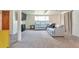 Spacious basement featuring a light blue sectional sofa with an entertainment area, ideal for leisure at 6484 Kendall St, Arvada, CO 80003