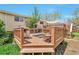 Inviting backyard deck featuring a built-in grill and fire pit, perfect for outdoor entertaining at 6484 Kendall St, Arvada, CO 80003