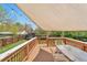 Relaxing deck area with shade cover, string lights, and patio seating overlooking the backyard at 6484 Kendall St, Arvada, CO 80003