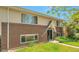 Brick and siding home with a well-manicured lawn and covered entryway at 6484 Kendall St, Arvada, CO 80003