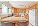Well-lit kitchen with light wood cabinetry, modern appliances, and a breakfast bar at 6484 Kendall St, Arvada, CO 80003