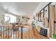 Inviting living room with wood floors, a hanging chair, and comfortable seating at 6484 Kendall St, Arvada, CO 80003
