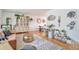 Bright living room featuring hardwood floors, stylish decor, and lots of natural light at 6484 Kendall St, Arvada, CO 80003