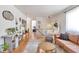 Open-concept living room featuring stylish decor, hardwood floors, and ample seating at 6484 Kendall St, Arvada, CO 80003