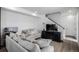 Bright living room with a large sectional sofa, television, and modern decor at 18199 E 96Th Ave, Commerce City, CO 80022