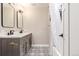 Bathroom with double sink vanity, framed mirrors, and a tub with shower at 230 E Highline Cir # 101, Centennial, CO 80122