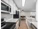 Stylish kitchen featuring herringbone backsplash, stainless appliances, and a farmhouse sink at 230 E Highline Cir # 101, Centennial, CO 80122