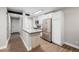 Bright kitchen featuring stainless steel appliances, white cabinets, and a modern island with breakfast bar at 230 E Highline Cir # 101, Centennial, CO 80122