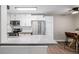 Bright kitchen features stainless appliances, white cabinets, and an adjacent dining area at 230 E Highline Cir # 101, Centennial, CO 80122