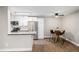 Kitchen featuring stainless appliances, white cabinets, and an adjacent dining area at 230 E Highline Cir # 101, Centennial, CO 80122