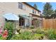 Relaxing backyard with garden, patio seating, and colorful flower arrangements at 3695 S Kittredge St # C, Aurora, CO 80013