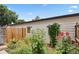 Charming backyard garden with a variety of flowers and greenery near the door at 3695 S Kittredge St # C, Aurora, CO 80013