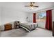 Bedroom with large window, ceiling fan, neutral walls and carpeting at 3695 S Kittredge St # C, Aurora, CO 80013