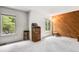 Spacious bedroom with natural light, wood accent wall and neutral carpet at 3695 S Kittredge St # C, Aurora, CO 80013