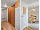 Hallway with wood-look floors, a closet, and an opening leading to a dining area with table and chairs at 3695 S Kittredge St # C, Aurora, CO 80013
