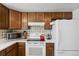 Well-lit kitchen with cabinetry, appliances, and a patterned backsplash at 3695 S Kittredge St # C, Aurora, CO 80013