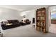 Comfortable living room featuring plush seating, open layout, and a bookshelf with personal items at 3695 S Kittredge St # C, Aurora, CO 80013