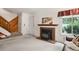 Inviting living room featuring a fireplace, stairwell, and a comfortable seating area with natural light at 3695 S Kittredge St # C, Aurora, CO 80013