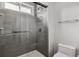 Modern shower with glass doors, multiple shower heads, and tiled surround at 3695 S Kittredge St # C, Aurora, CO 80013