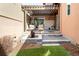 Charming backyard retreat with a stone patio, a tranquil water feature, and lush green turf at 89 Oneida St, Denver, CO 80230