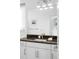 Bathroom with sleek vanity, granite countertop, and large mirror at 89 Oneida St, Denver, CO 80230
