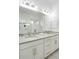 Modern bathroom featuring a double vanity with stone countertop and decorative mirrors at 89 Oneida St, Denver, CO 80230