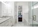Bright bathroom with double doors, modern vanity, and a glass-enclosed shower at 89 Oneida St, Denver, CO 80230