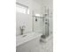Modern bathroom showcasing a freestanding tub, glass-enclosed shower, and stylish fixtures at 89 Oneida St, Denver, CO 80230