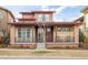 Charming home featuring a cozy front porch with rocking chairs and attractive architectural details at 89 Oneida St, Denver, CO 80230
